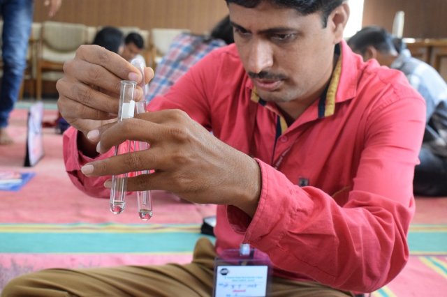 A teacher doing the practical of Titration.